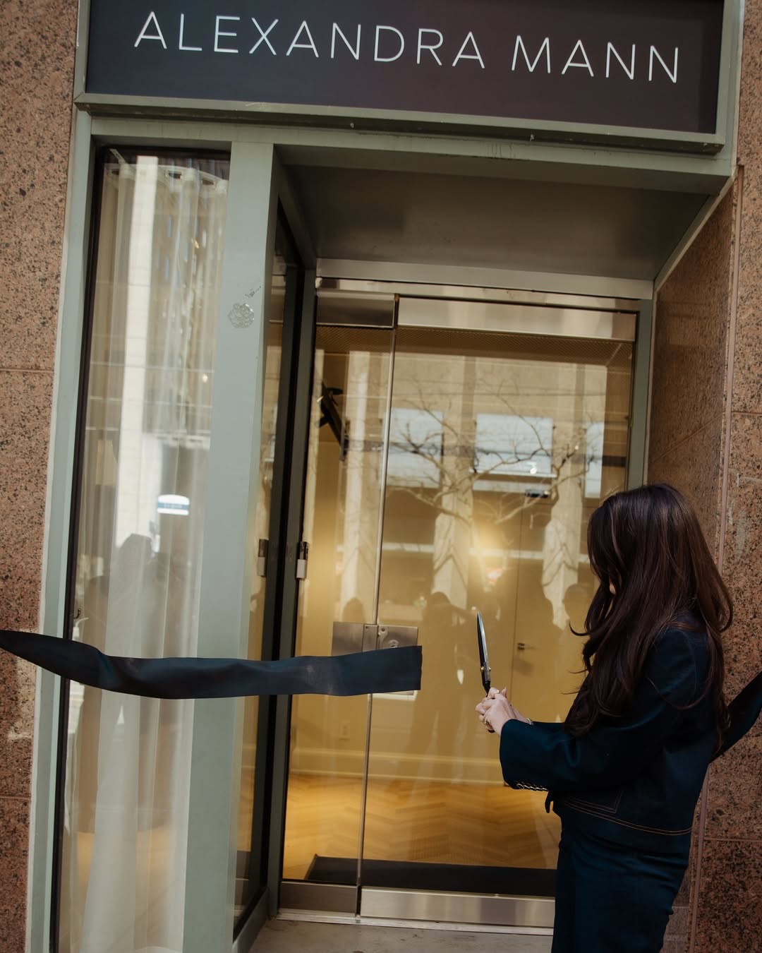 The glass entrance at Alexandra Mann Jewelry’s ribbon cutting
